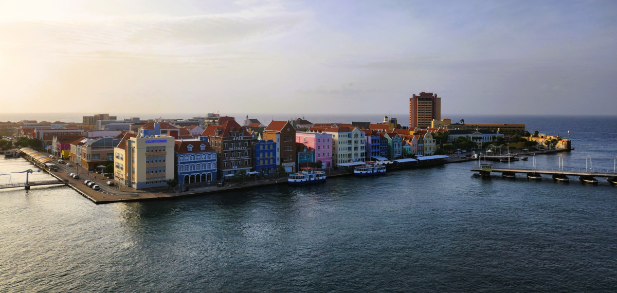 Curacao Cruise port floating bridge Willemstad 2 - Dohrn Travels Colorful waterfront buildings and Queen Emma Bridge at Willemstad cruise port, Curaçao – iconic Caribbean island arrival view