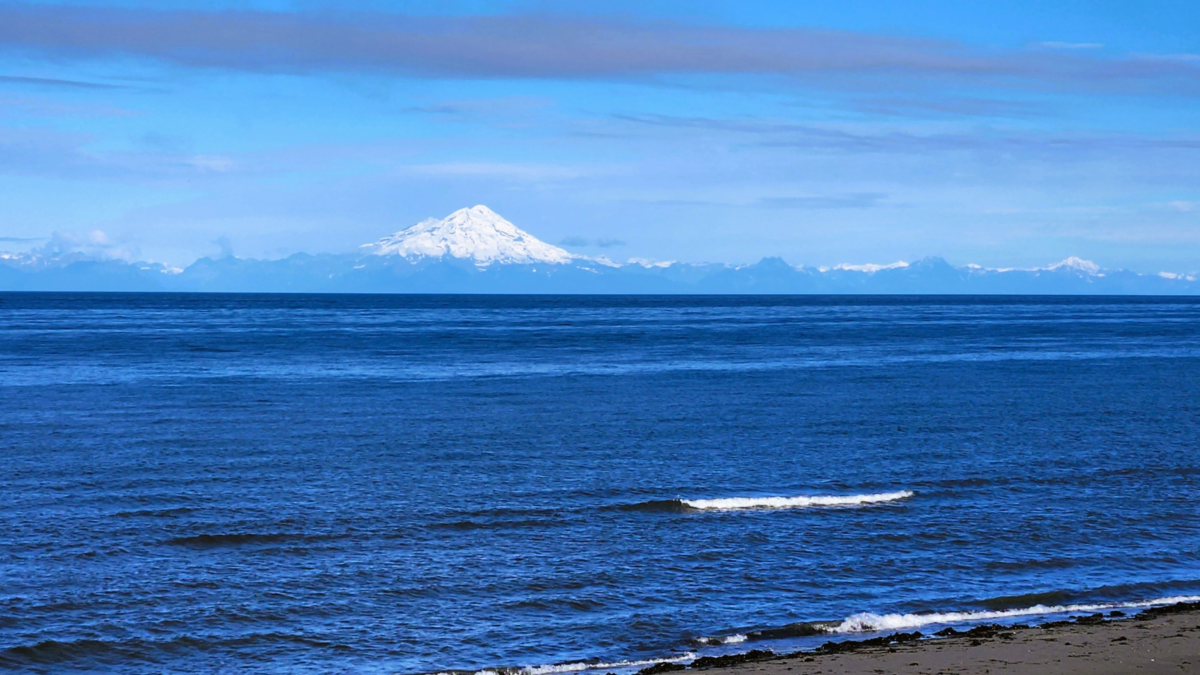 Cook Inlet Mountain View – Anchor River State Recreation Area, Alaska - Dohrn Travels Snow-capped mountain view across Cook Inlet from Anchor River State Recreation Area in Alaska.