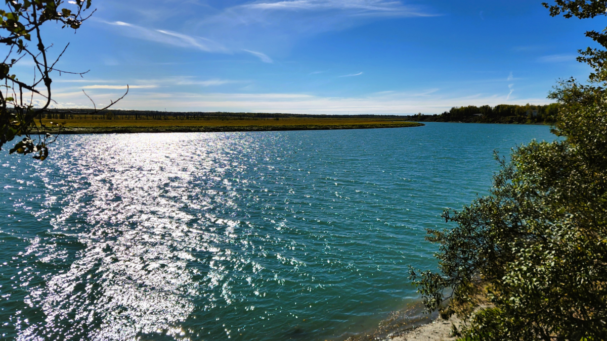Cunningham Park Kenai River Flats, Alaska - Dohrn Travels Scenic view of the Kenai River Flats from Cunningham Park in Kenai, Alaska, with sparkling blue water and clear skies.