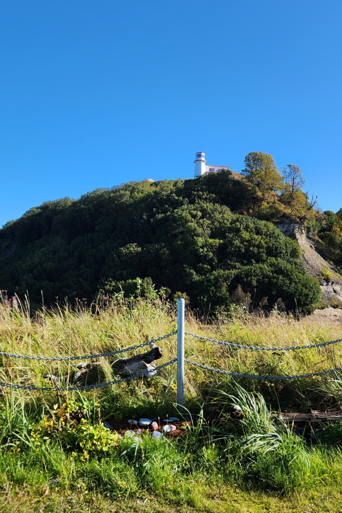Deep Creek Park Lighthouse in Ninilchik, Alaska - Dohrn Travels Lighthouse overlooking the bluffs at Deep Creek State Recreation Area in Ninilchik, Alaska, surrounded by fall colors and blue sky.