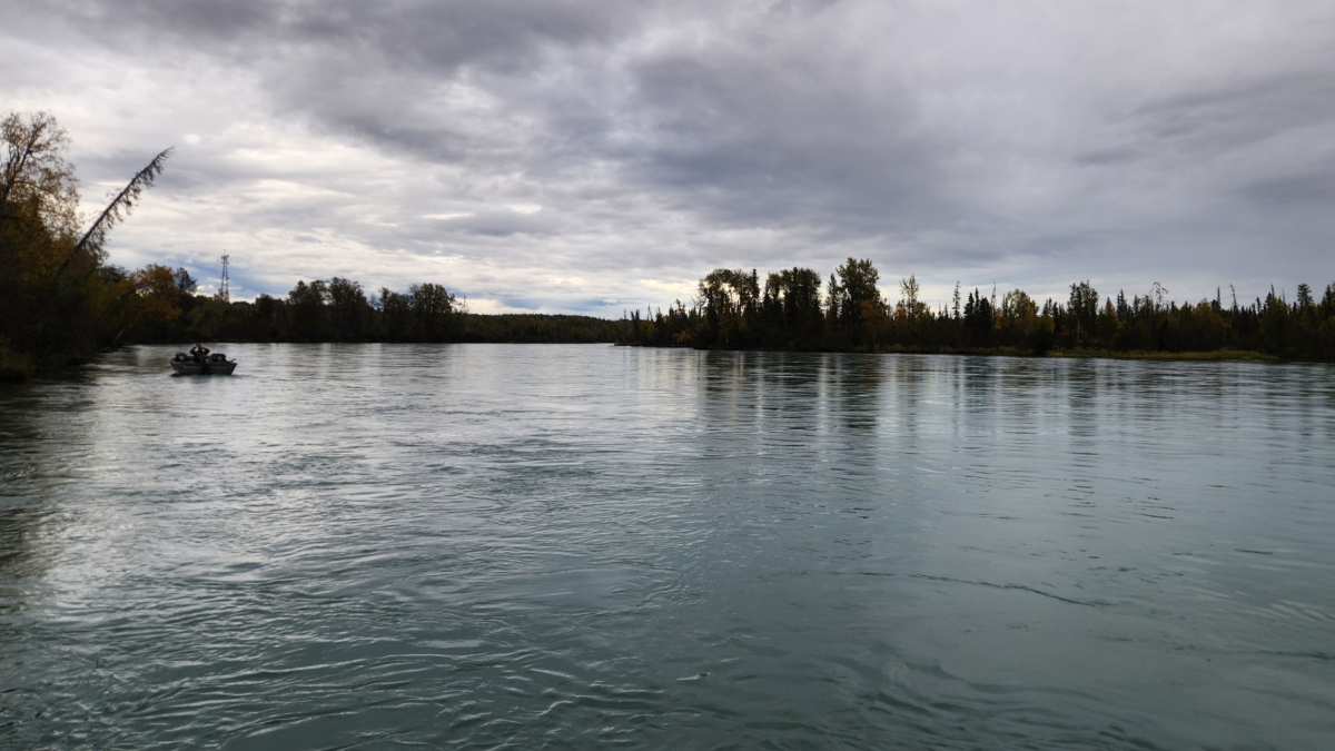 Kenai River View with Fishing Boat and Nature - Dohrn Travels Peaceful view of the Kenai River with a fishing boat surrounded by nature and autumn colors in Alaska.