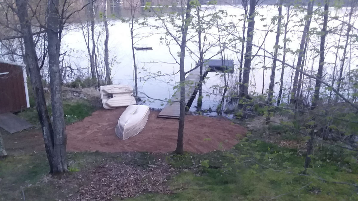 Lakeside area with small boats and dock at the Bears Den cabin on Perch Lake near Winter, Wisconsin