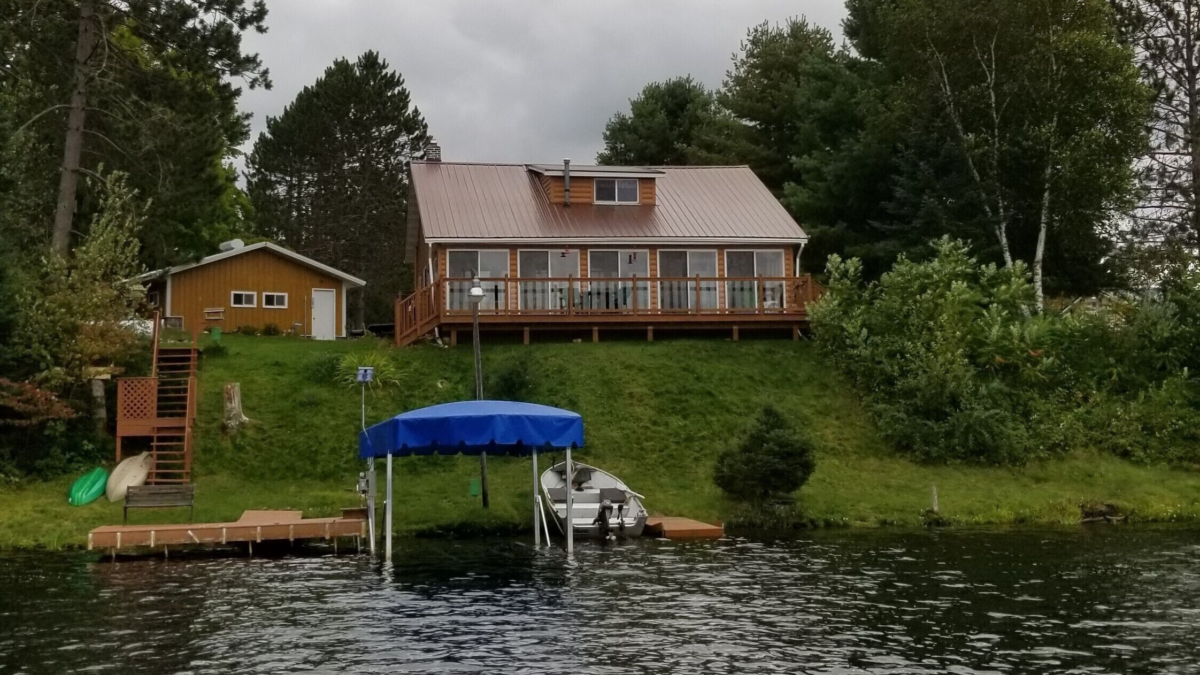 Four-season lakefront cabin on Black Dan Lake near Winter, Wisconsin with boat dock and hillside deck