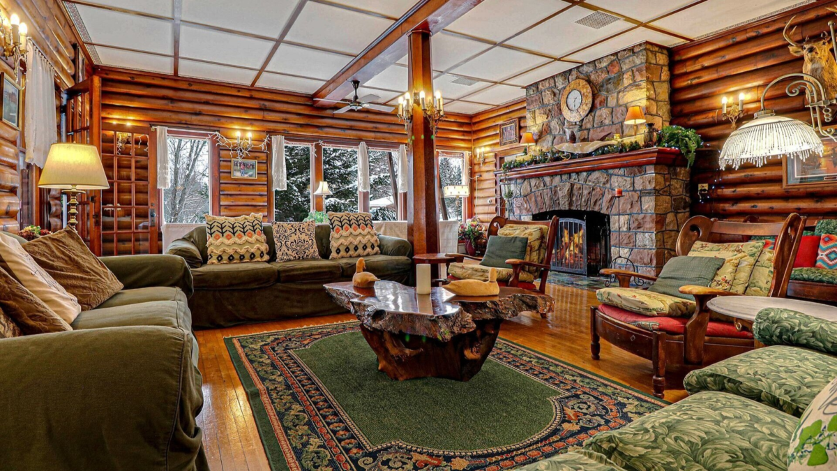 Rustic log interior with stone fireplace at the Historic Prohibition Lodge on Barker Lake near Winter, Wisconsin