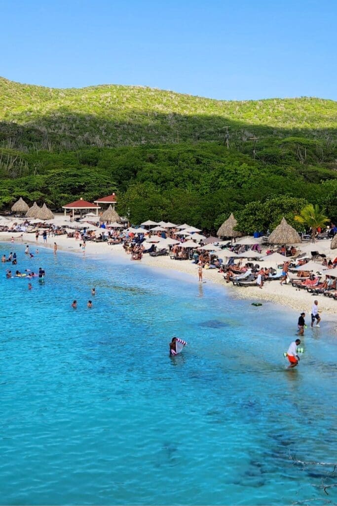 Grote Knip Beach Amenities and Crowd Levels - Dohrn Travels Crowded afternoon at Grote Knip Beach Curaçao with umbrellas and swimmers